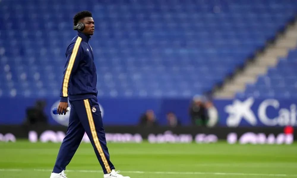 Player walking on pitch in warm-up attire