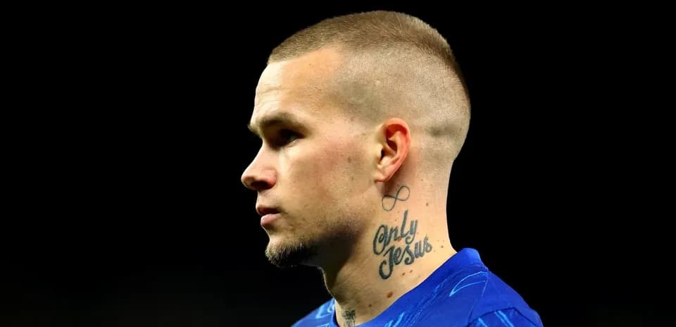 Player in blue jersey with tattoos on neck
