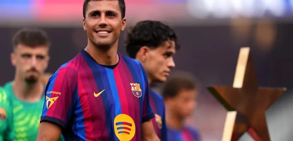 Player smiling while holding a star trophy