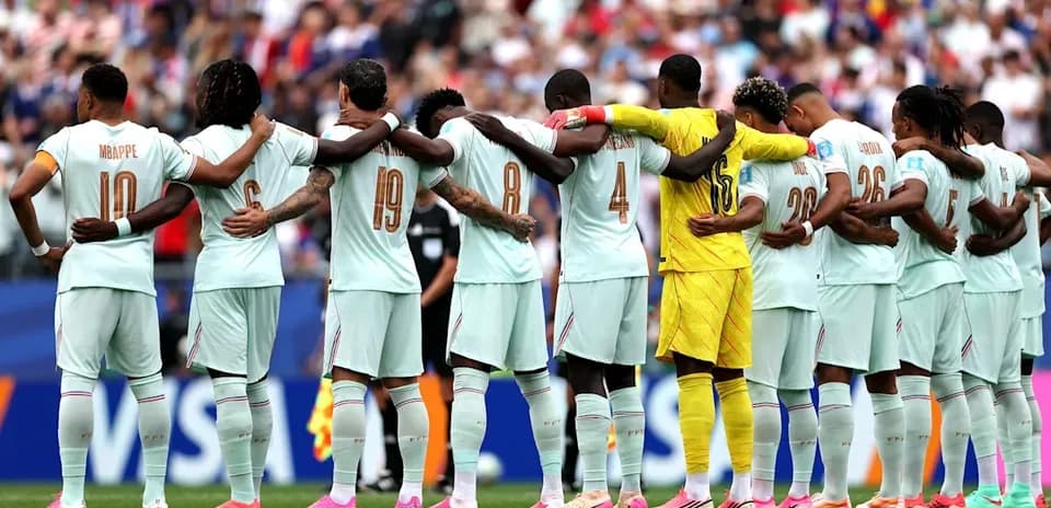 Football team standing in solidarity before match