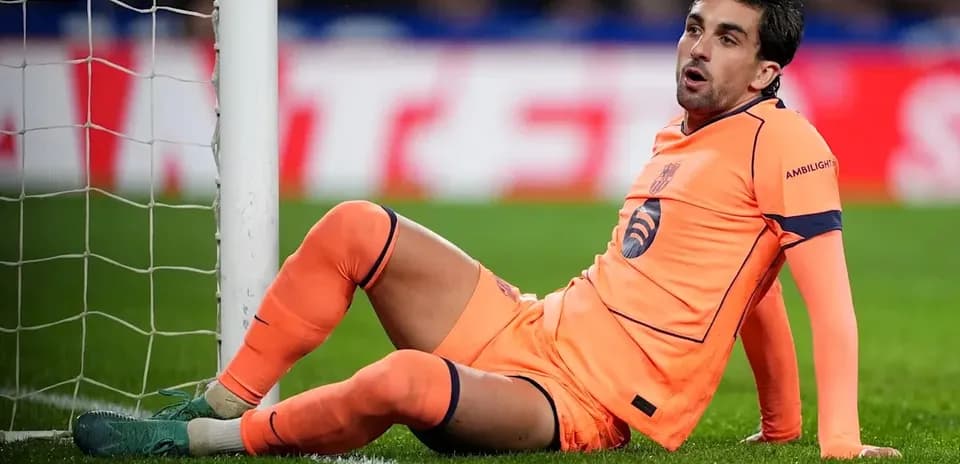 Goalkeeper sitting near the goal post during match