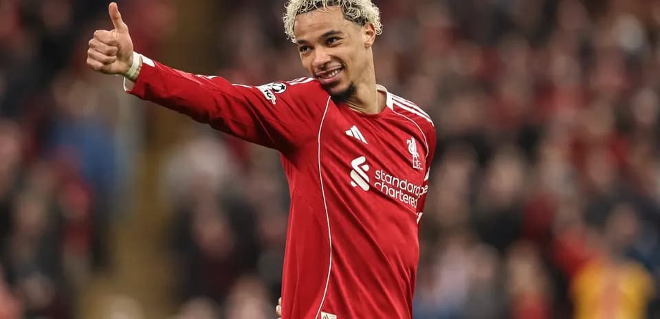 Player celebrating with thumbs up in Liverpool jersey