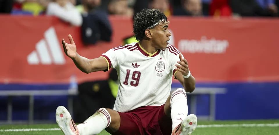 Player from Spain sitting on the pitch
