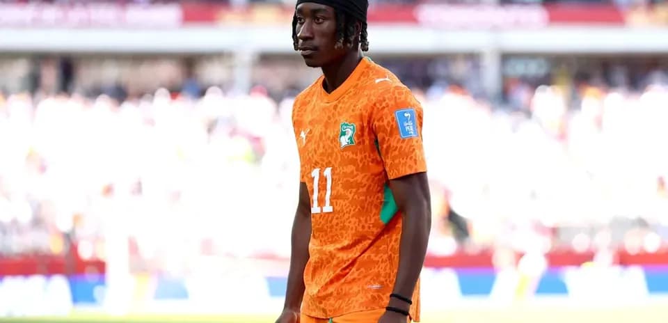 Player wearing orange jersey during warm-up on field