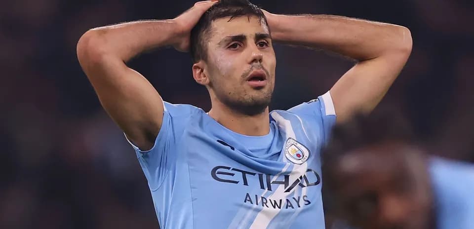 Player holding head in disappointment on the pitch