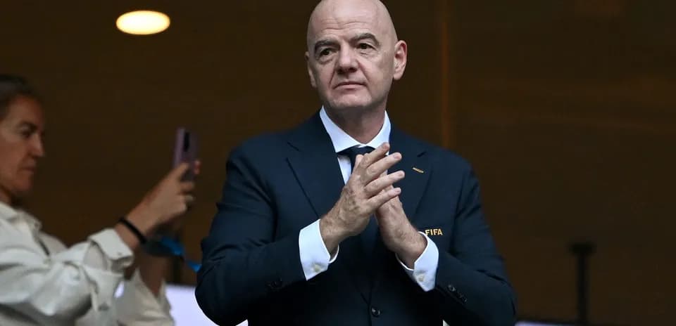 FIFA official clapping in stadium box