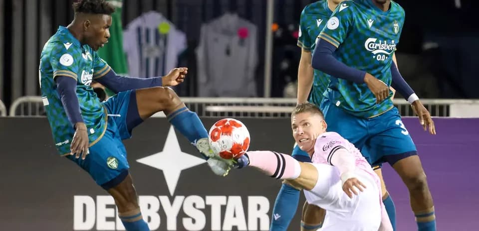 Player attempting a tackle during Vancouver FC match