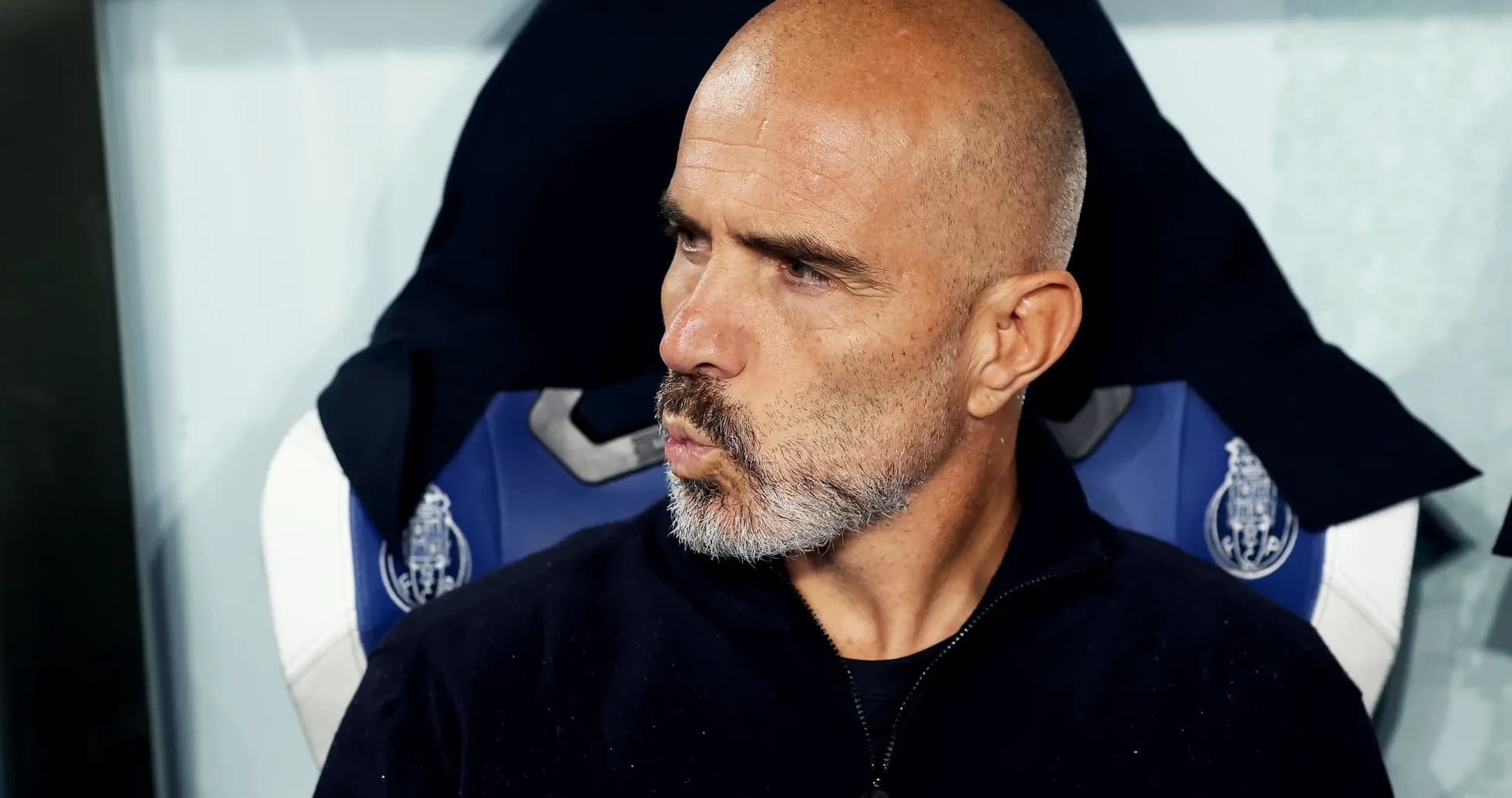 Coach sitting on bench during match