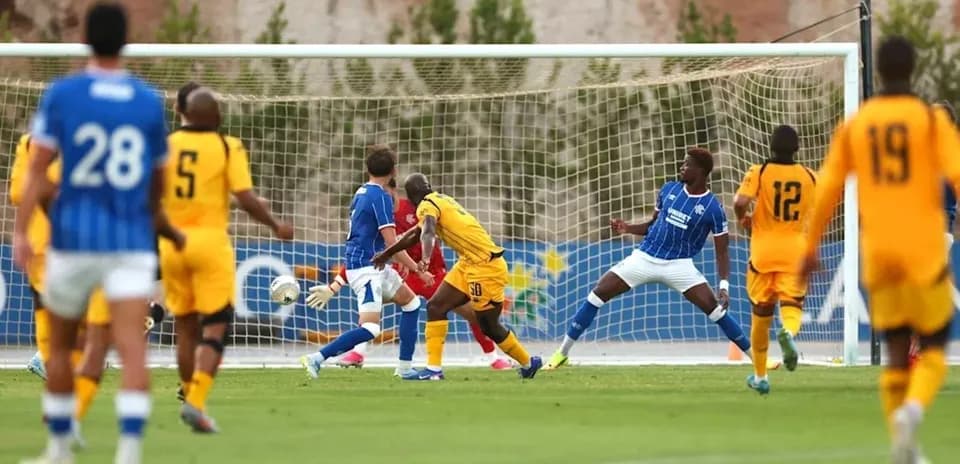 Player shooting at goal during soccer match