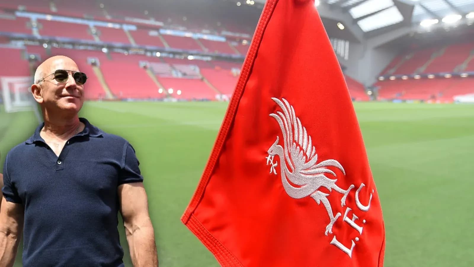 Person standing near Liverpool FC flag at stadium