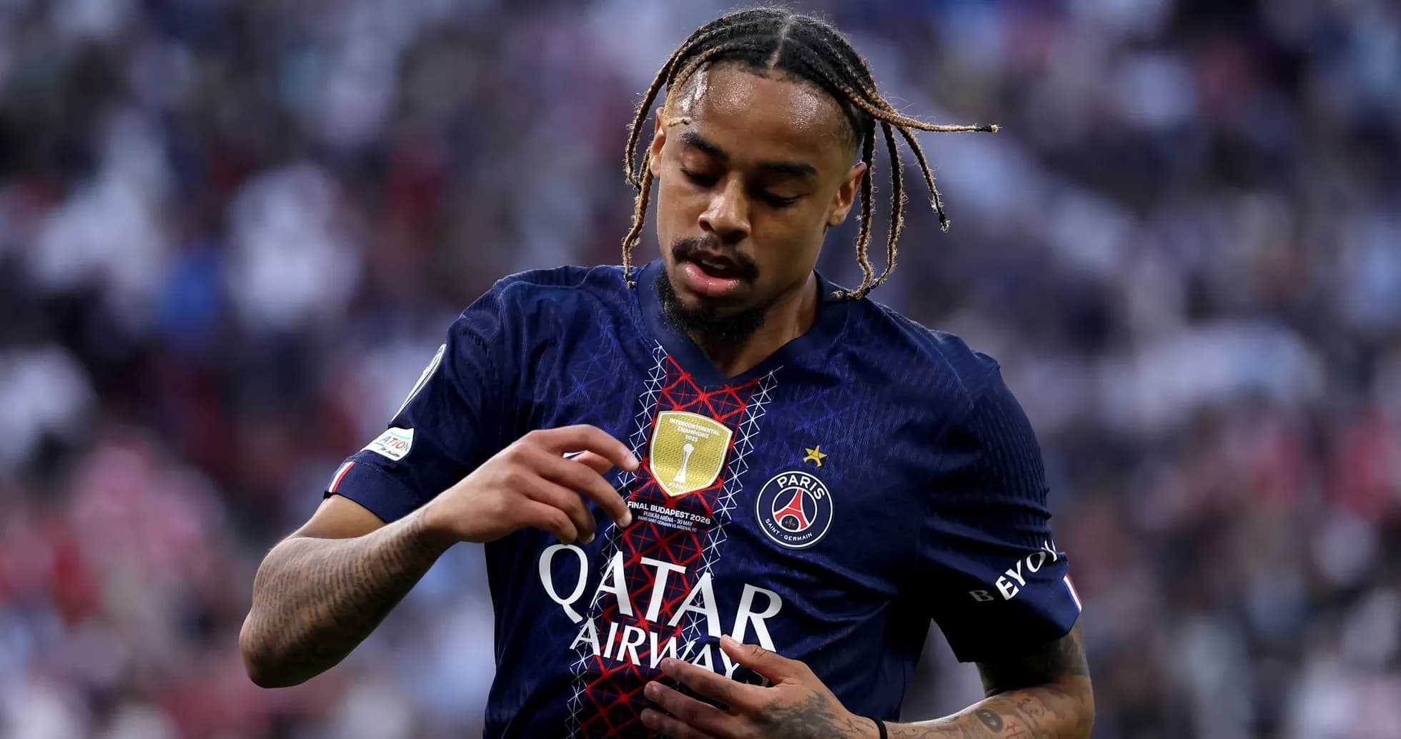 Player inspecting jersey badge during match