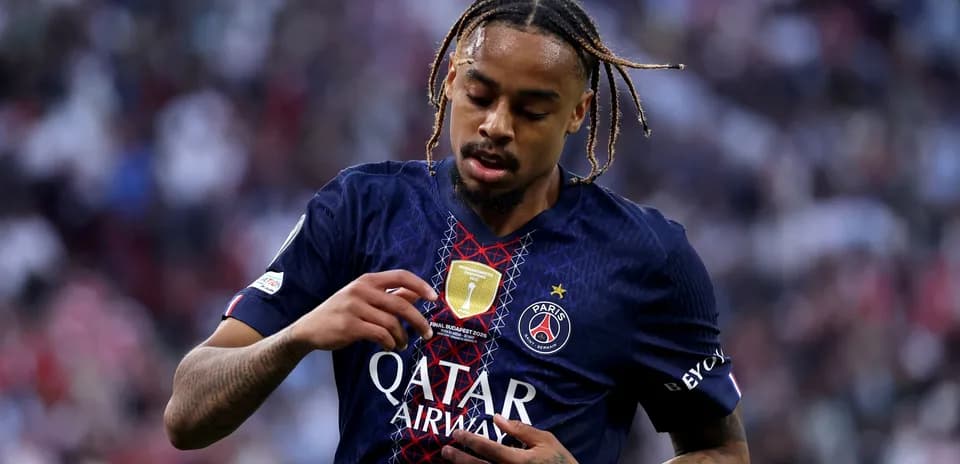 Player inspecting jersey badge during match