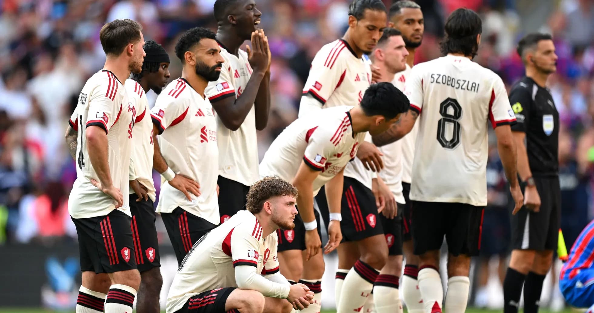 Players in white jerseys waiting during a match