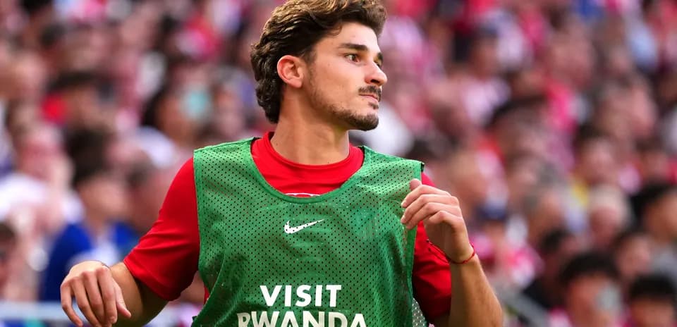 Player in green training bib on sideline
