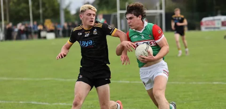 Two players competing for the ball in a match