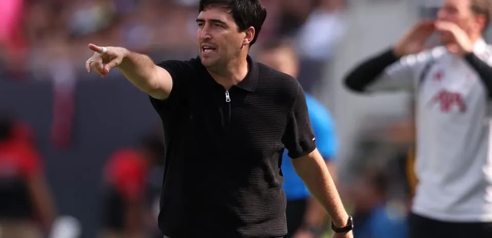 Coach giving instructions from the sideline during match