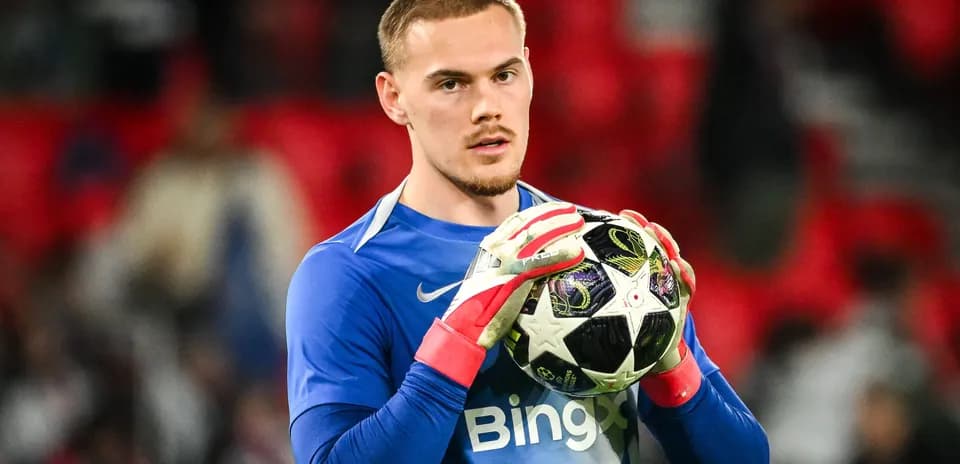 Goalkeeper holding ball during match warm-up