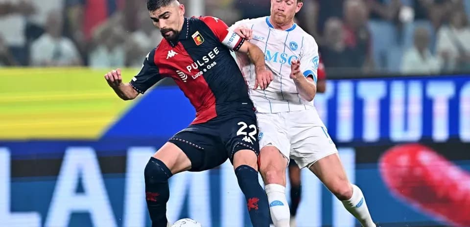 Genoa player tackles Napoli player during match