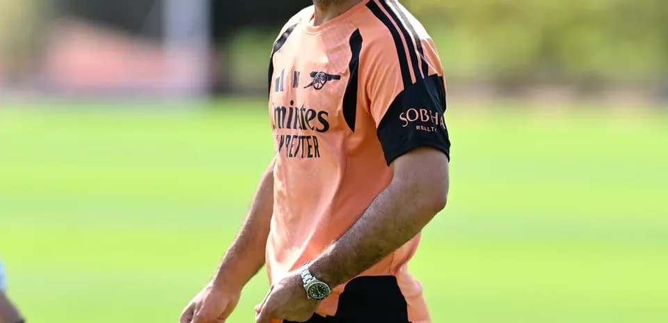 Manager smiling during training session on pitch