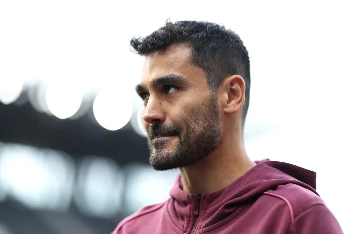 Player in maroon hoodie at stadium entrance