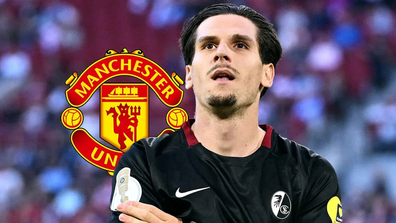 Player in black kit with Manchester United logo behind