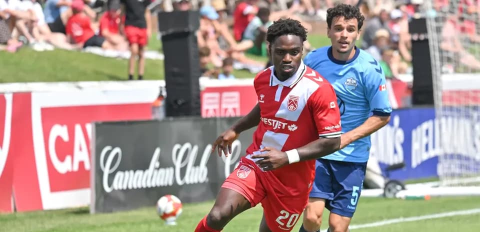 Cavalry FC player dribbling during match