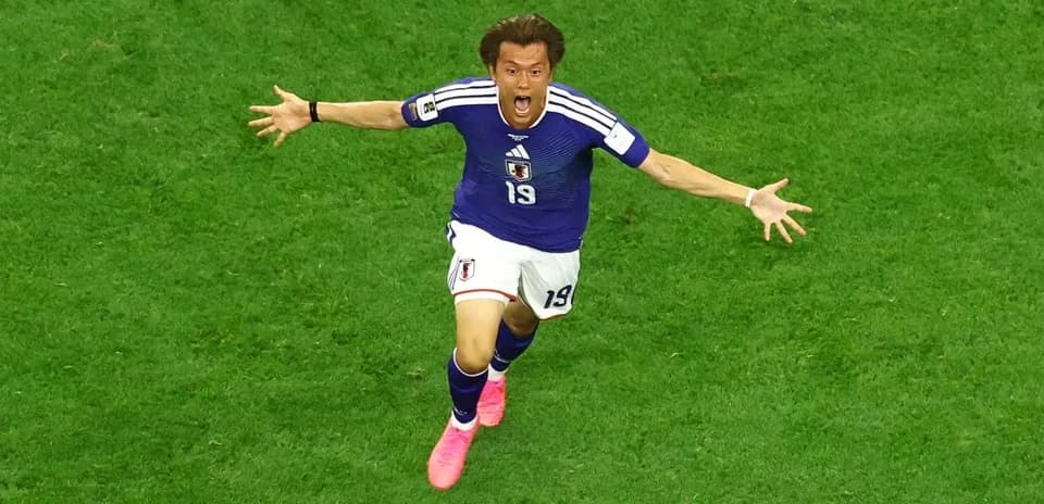 Japanese player celebrating during football match
