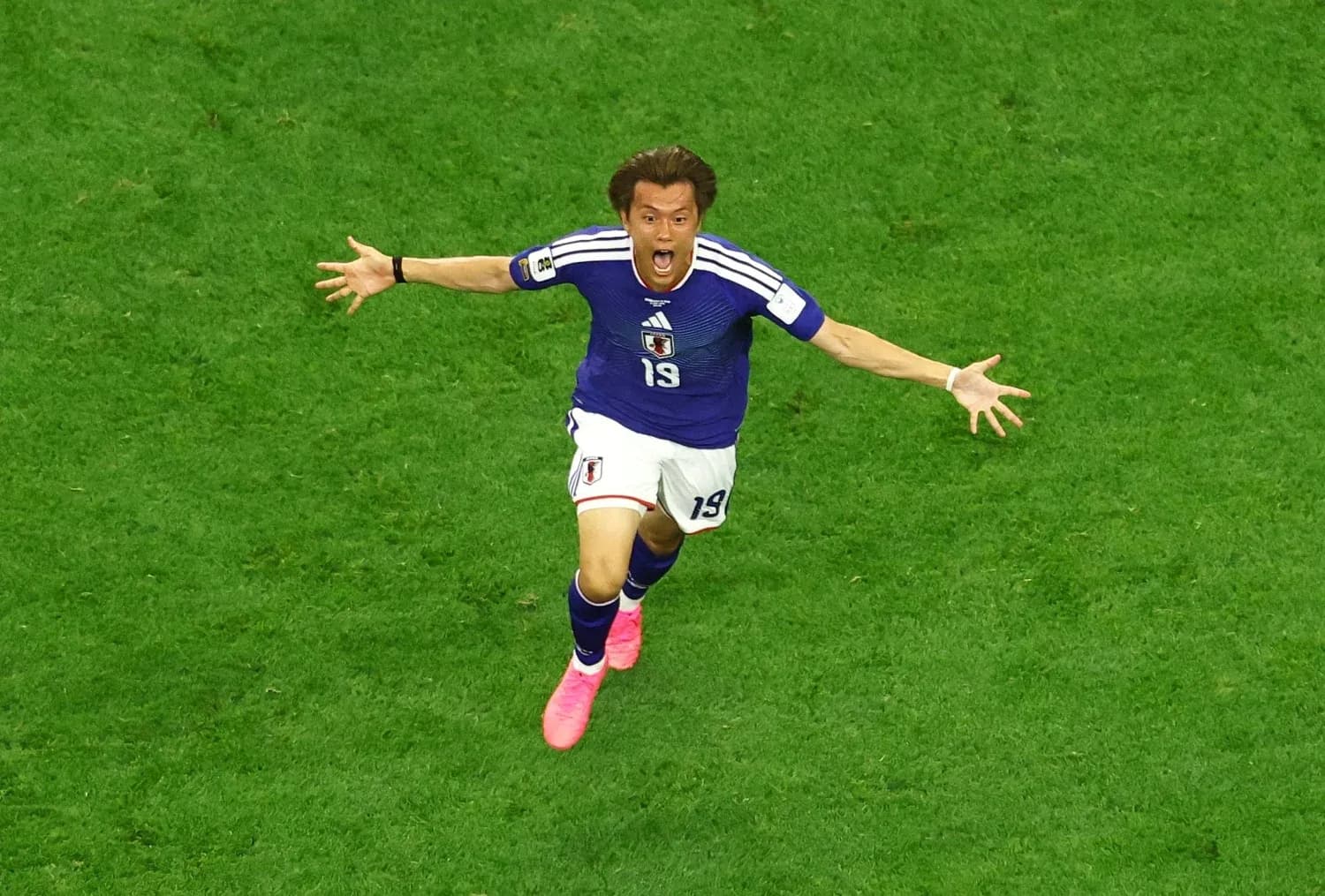 Japanese player celebrating during football match