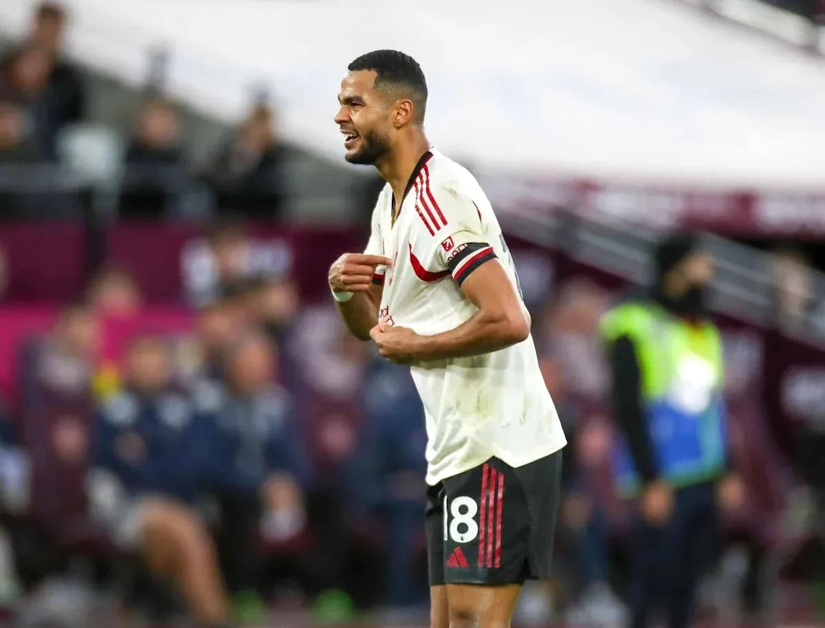 Player reacting during match, wearing red and white kit