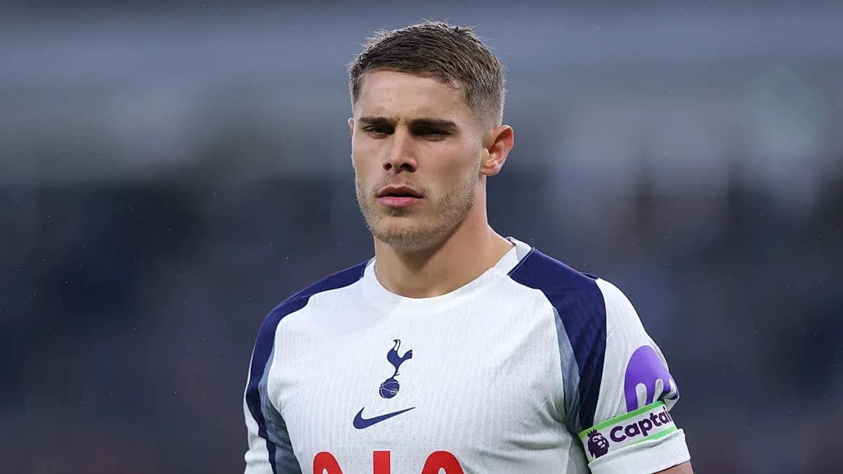 Player wearing Tottenham jersey with captain's armband