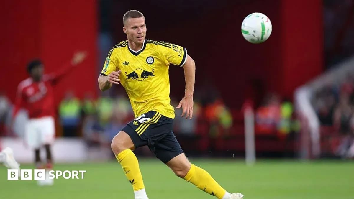 Player in yellow jersey chasing a soccer ball