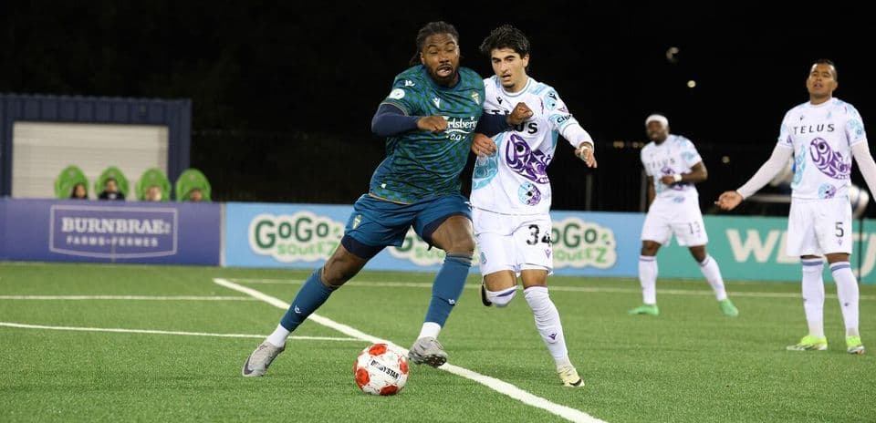 Pacific FC player dribbling past York United defender