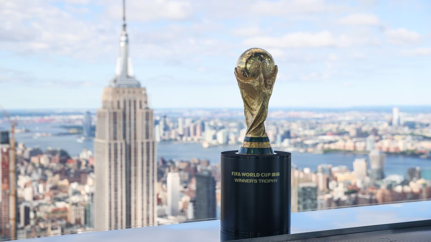 FIFA World Cup trophy with city skyline background