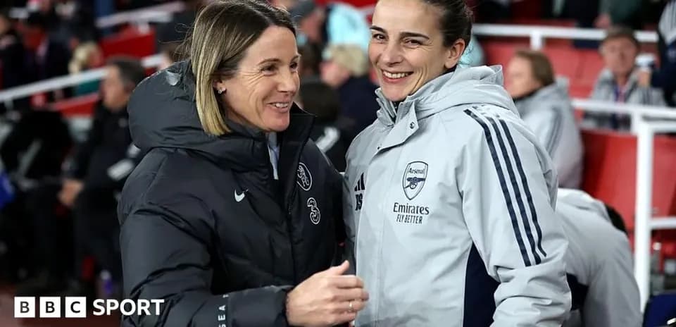 Coaches chatting on the sidelines before the match