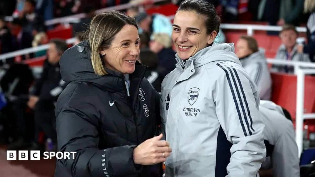 Coaches chatting on the sidelines before the match