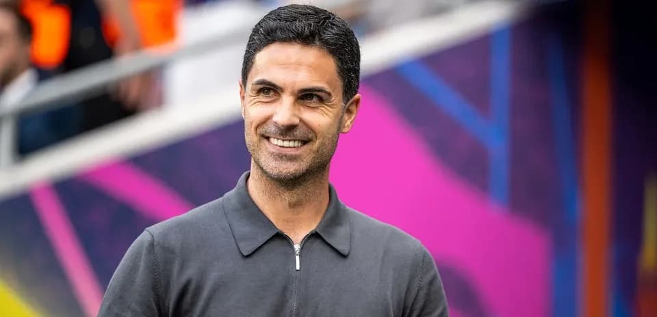 Manager smiling on sidelines before match