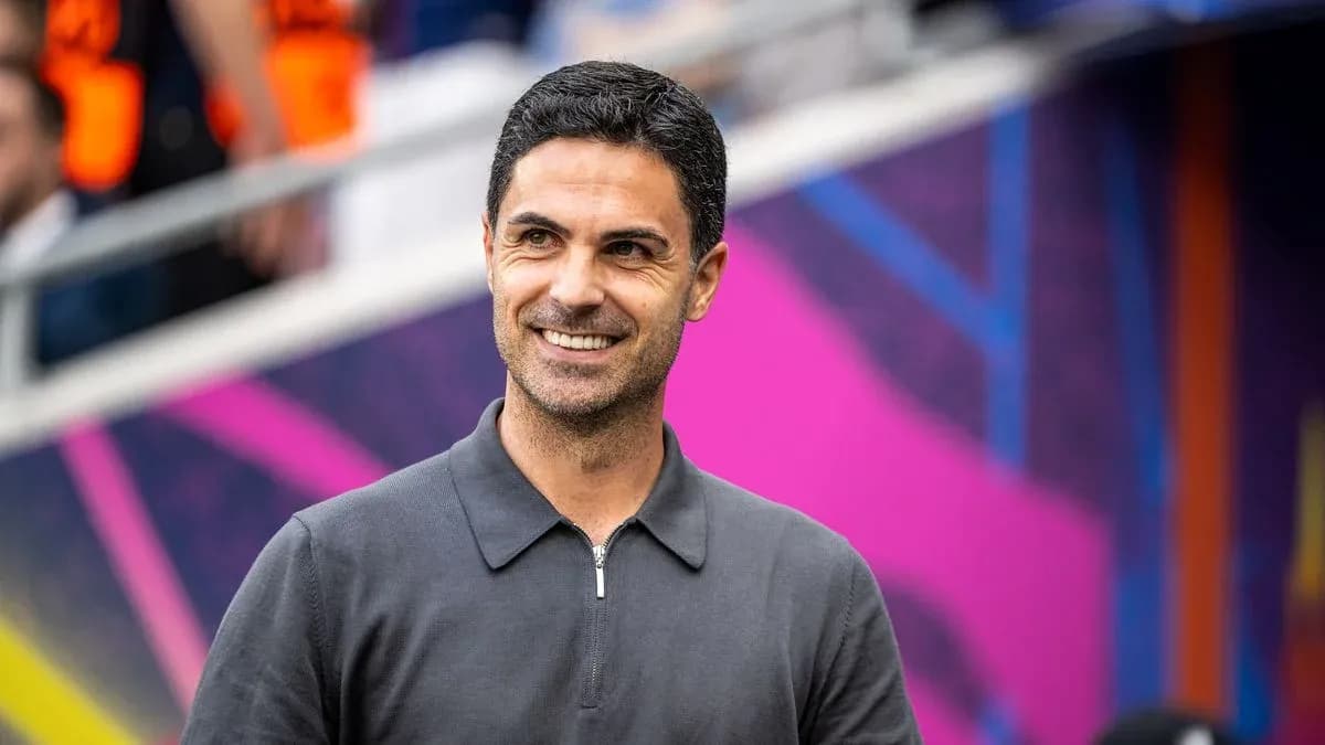 Manager smiling on sidelines before match