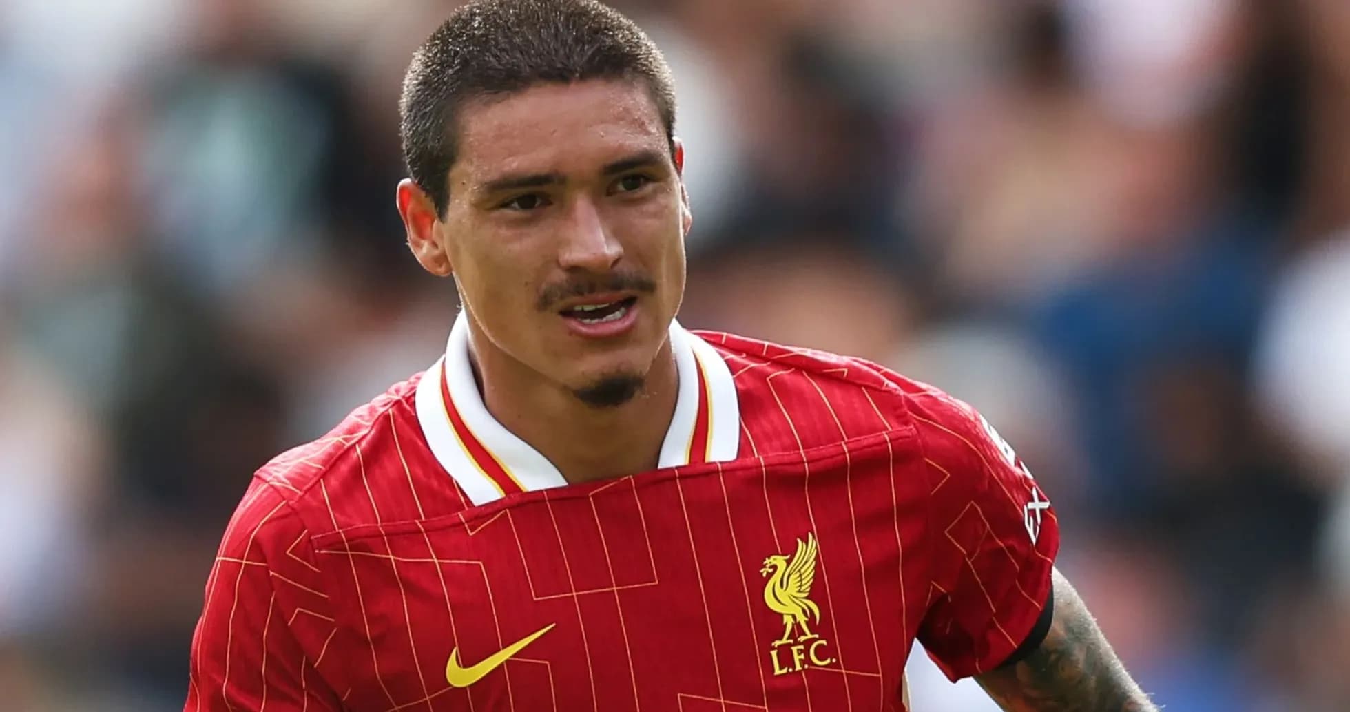 Player in red Liverpool jersey running on field