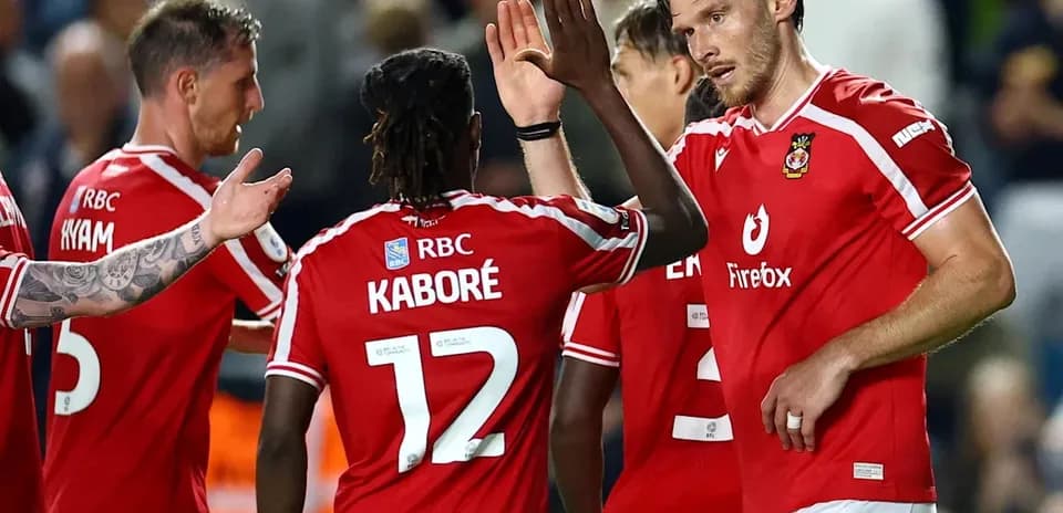 Players celebrating a goal in red jerseys
