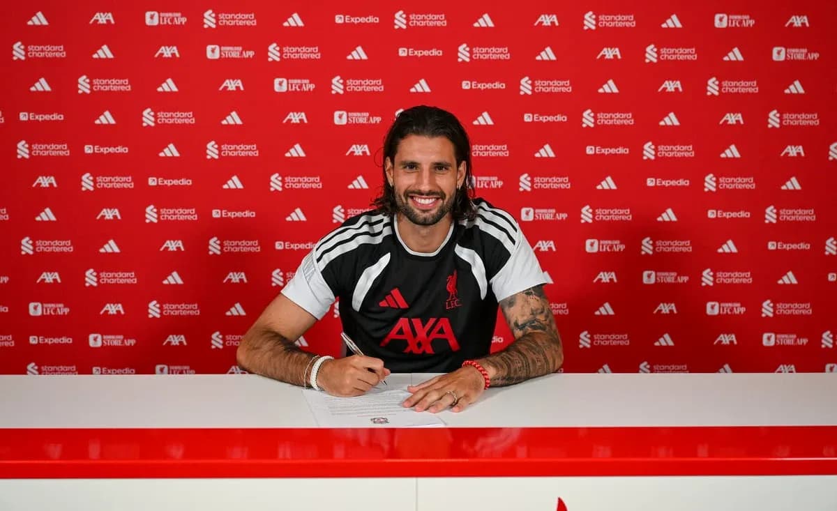 Player signing contract at Liverpool FC press conference