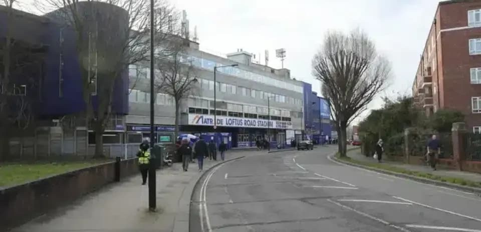 Exterior view of Loftus Road Stadium with pedestrians