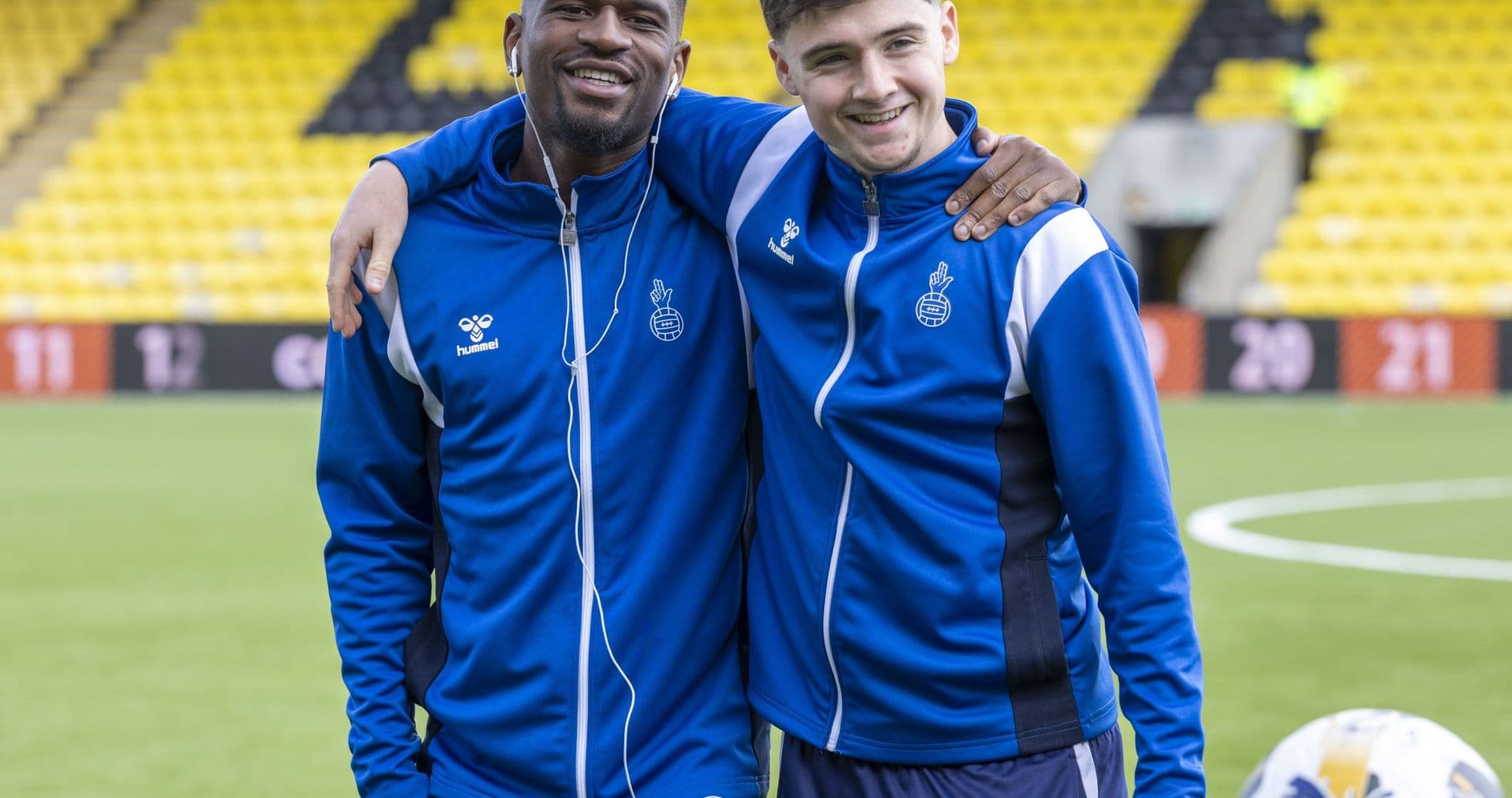 Two players posing together on the field
