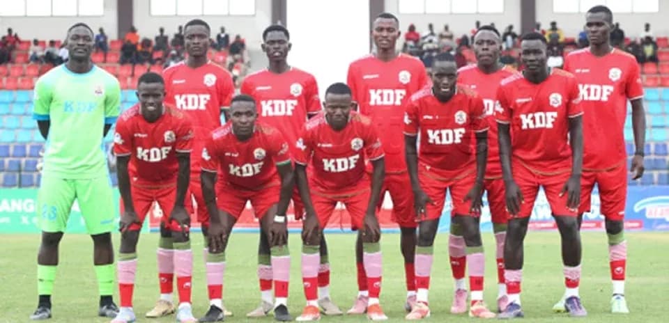KDF football team posing for team photo on field