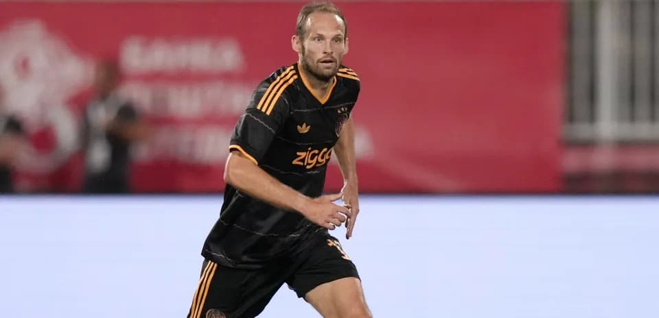 Player in Ajax uniform running on the field