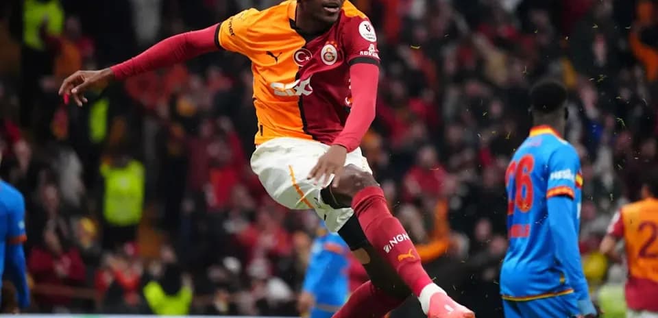 Player celebrating a goal wearing a mask