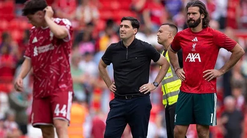 Liverpool players and coach on the pitch during match