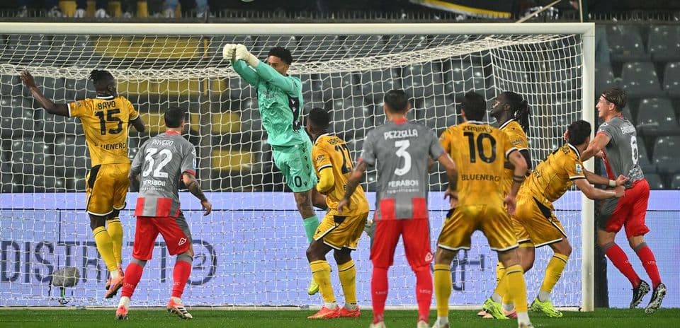 Goalkeeper saves a shot during Udinese match