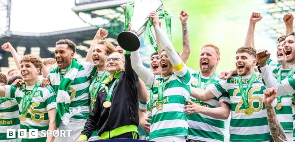 Celtic players celebrating with trophy after victory