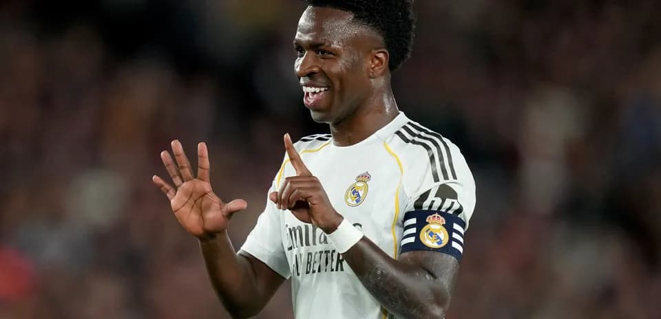 Player celebrating on the field wearing Real Madrid jersey