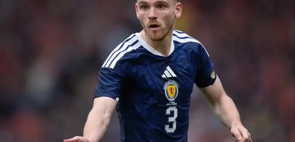 Player gesturing during a football match in Scotland kit